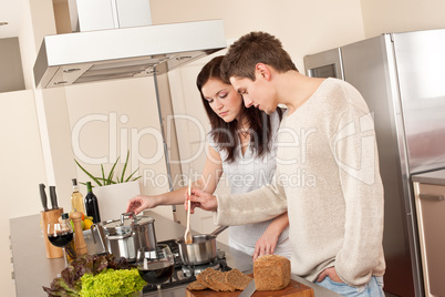 Young couple cooking in kitchen together