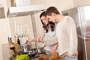 Young couple cooking in kitchen together