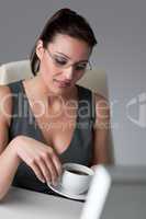 Successful business woman having coffee break at office