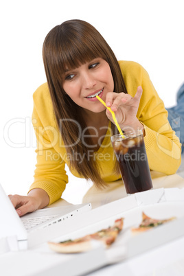 Happy female teenager with laptop lying down