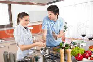 Young happy couple cooking in kitchen