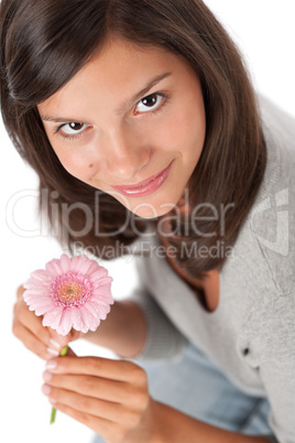 Teenager holding gerbera daisy