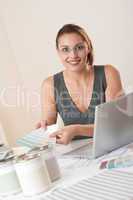 Young female designer working at office with laptop