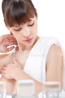 Body care: Young woman applying lotion