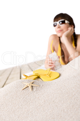 Beach - starfish on sand, woman in bikini in background