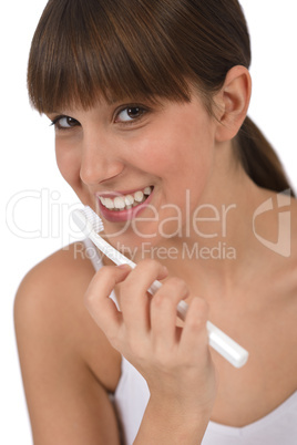 Body care - Female teenager brushing teeth