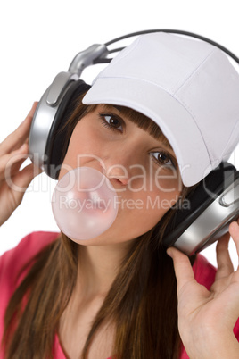 Female teenager with bubble gum and headphones
