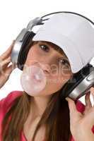 Female teenager with bubble gum and headphones