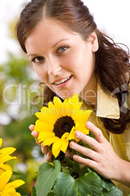 Portrait of beautiful woman with sunflowers