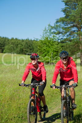 Young couple with mountine bike in spring nature