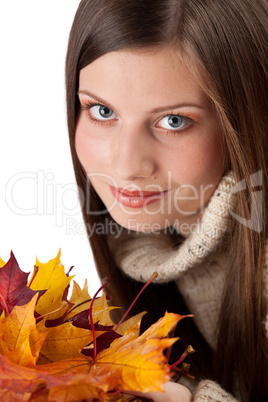 Autumn portrait of beautiful woman with leaf wearing turtleneck