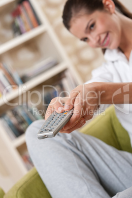 Students - Smiling female teenager with remote control