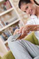 Students - Smiling female teenager with remote control