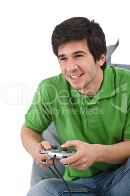 Young happy man playing video game with control pad