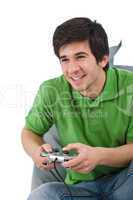 Young happy man playing video game with control pad