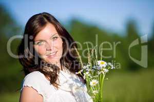 Beautiful woman with flowers on sunny day