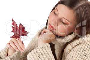 Autumn portrait of beautiful woman with leaf