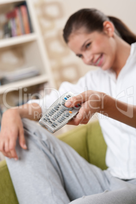 Students - Smiling female teenager with remote control