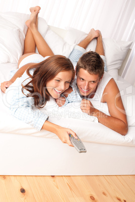 Young man and woman lying down in lounge