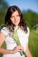 Beautiful woman with flowers on sunny day