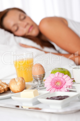 Young woman having breakfast in bed