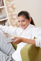Students - Smiling female teenager with remote control