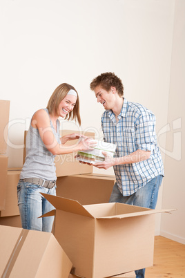 Moving house: Young couple with box in new home