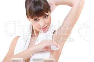 Body care: Young woman applying deodorant