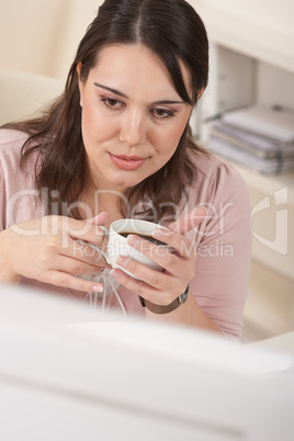 Young business woman enjoying coffee at modern office