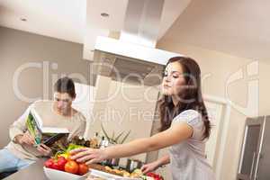 Young couple cooking in kitchen together