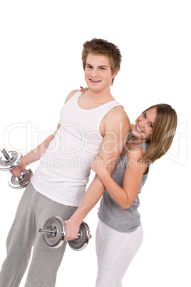 Fitness - Smiling healthy couple exercising with weights