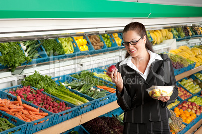 Grocery store shopping - Business woman holding apple