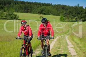 Young couple with mountine bike in spring nature