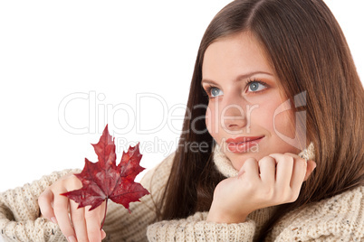 Autumn portrait of beautiful woman with leaf wearing turtleneck