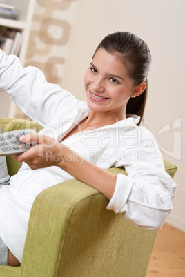 Students - Smiling female teenager with remote control