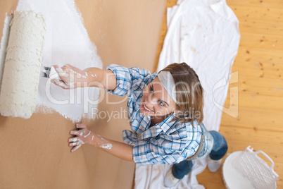 Home improvement: Woman painting wall