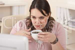 Happy businesswoman having coffee break at office