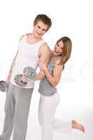 Fitness - Smiling healthy couple exercising with weights