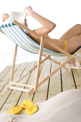 Beach - topless woman sitting on deckchair