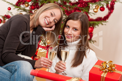 Two young woman with champagne on Christmas