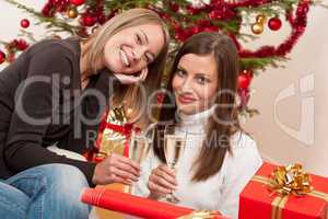 Two young woman with champagne on Christmas