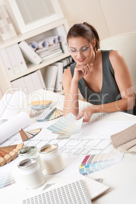 Female interior designer working with color swatch