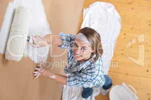 Home improvement: Young woman painting wall