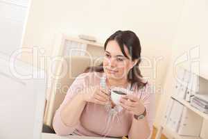 Young business woman enjoying coffee at modern office