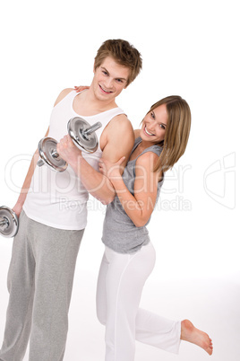 Fitness - Smiling healthy couple exercising with weights