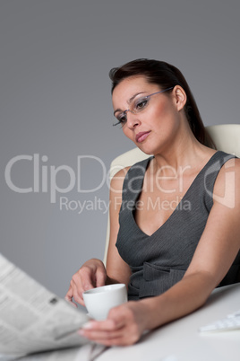 Successful businesswoman read newspaper at office