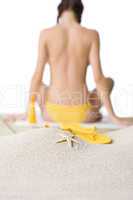 Beach - starfish with flip-flop on sand, woman in background