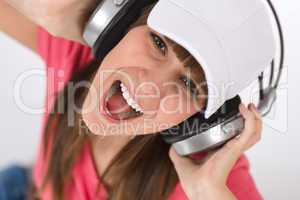 Female teenager singing with headphones