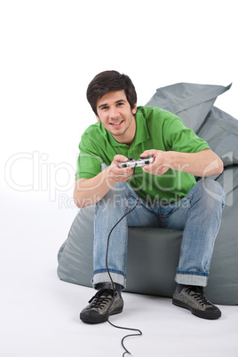 Young happy man playing video game with control pad