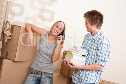 Moving house: Young couple with box in new home